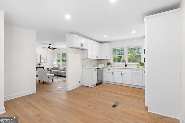 kitchen with dishwasher, a sink, light wood finished floors, ceiling fan, and recessed lighting