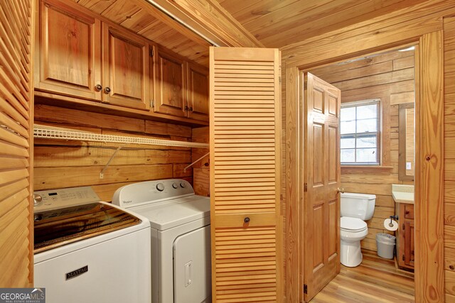 2425 Hines Gap Rd, Warm Springs, GA 31830 - laundry area featuring separate washer and dryer, wood walls, and light wood-style floors