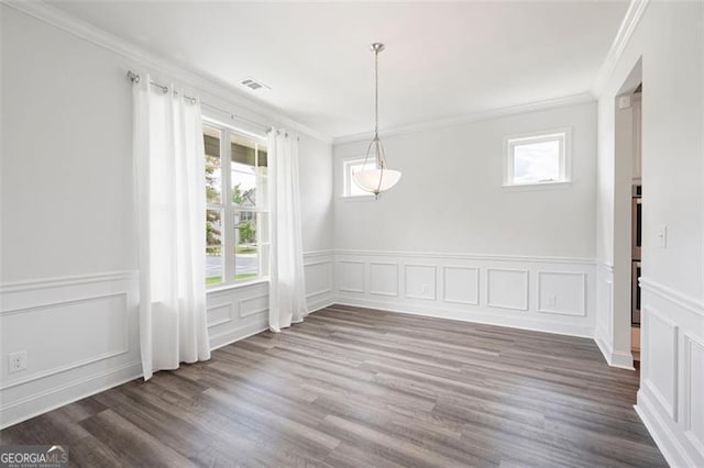 1809 Hanwoo Ln, Powder Springs, GA 30127 - unfurnished dining area with ornamental molding, a decorative wall, plenty of natural light, a wainscoted wall, and wood finished floors