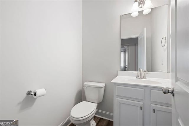 1809 Hanwoo Ln, Powder Springs, GA 30127 - bathroom featuring toilet, vanity, wood finished floors, and baseboards