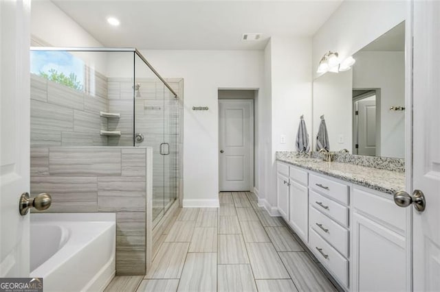 1809 Hanwoo Ln, Powder Springs, GA 30127 - bathroom featuring vanity, a garden tub, a stall shower, and baseboards