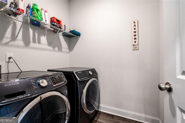 1809 Hanwoo Ln, Powder Springs, GA 30127 - clothes washing area featuring washer and dryer, baseboards, and dark wood-style flooring