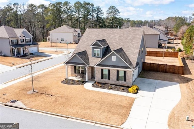 1809 Hanwoo Ln, Powder Springs, GA 30127 - view of front of property featuring fence, covered porch, brick siding, a residential view, and driveway