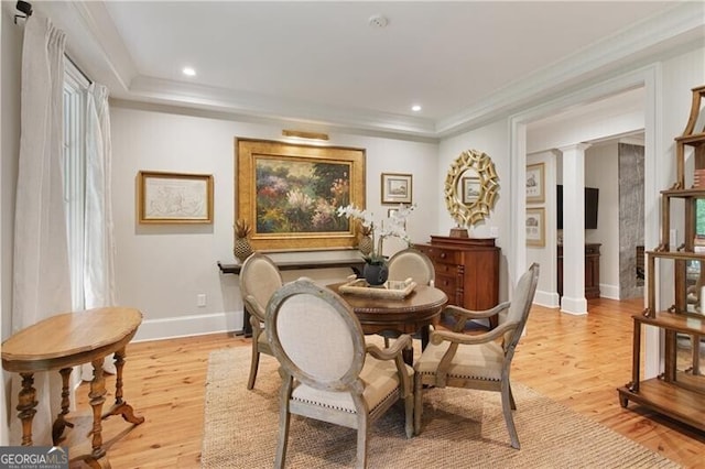living area with decorative columns, light wood finished floors, baseboards, ornamental molding, and recessed lighting