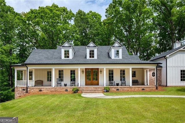 view of front of home with covered porch, a front yard, french doors, and roof with shingles
