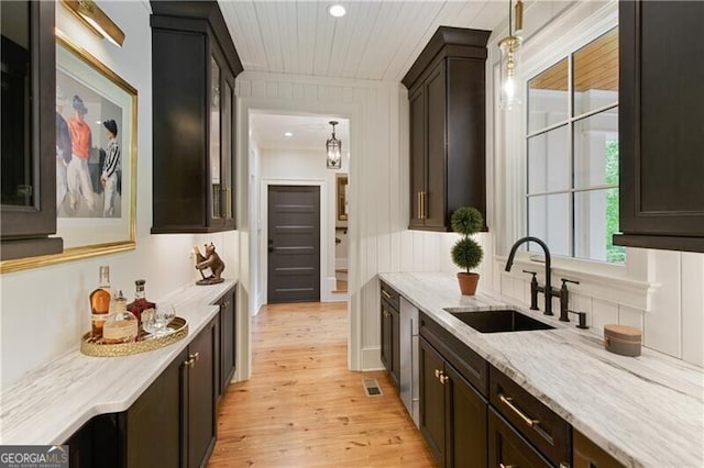bar area featuring a sink, light wood finished floors, hanging light fixtures, wooden ceiling, and recessed lighting