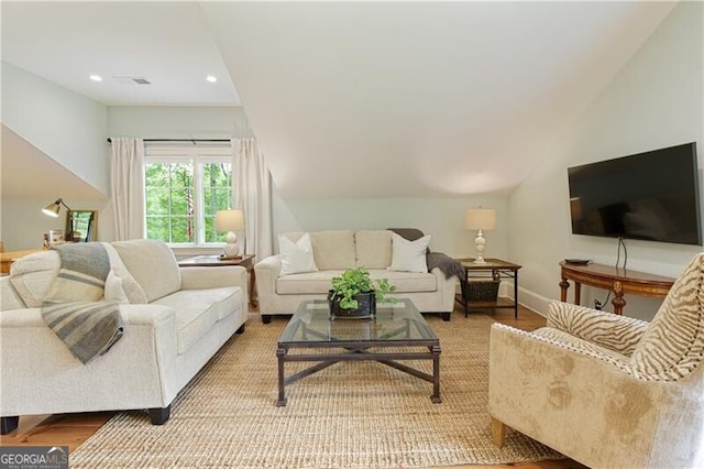 living area with lofted ceiling, recessed lighting, and baseboards