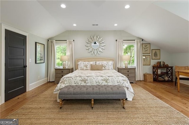 bedroom with lofted ceiling, wood finished floors, recessed lighting, and baseboards
