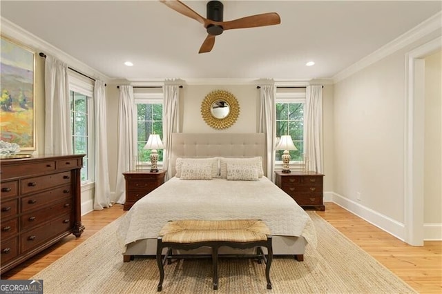 bedroom featuring crown molding, multiple windows, light wood finished floors, baseboards, and recessed lighting