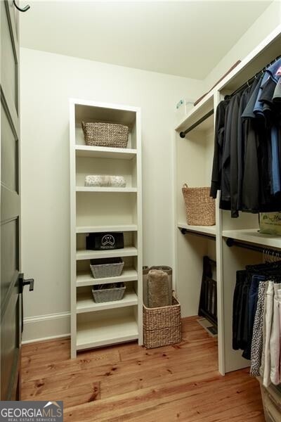 spacious closet featuring wood finished floors