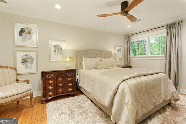 bedroom featuring crown molding, wood finished floors, baseboards, recessed lighting, and ceiling fan