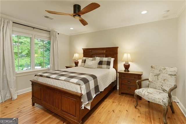 bedroom with ornamental molding, light wood-style floors, baseboards, ceiling fan, and recessed lighting