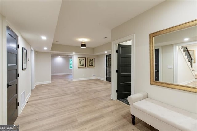 sitting room featuring stairs, light wood finished floors, recessed lighting, and baseboards