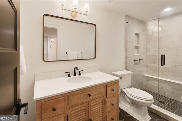 full bathroom featuring toilet, a stall shower, and vanity