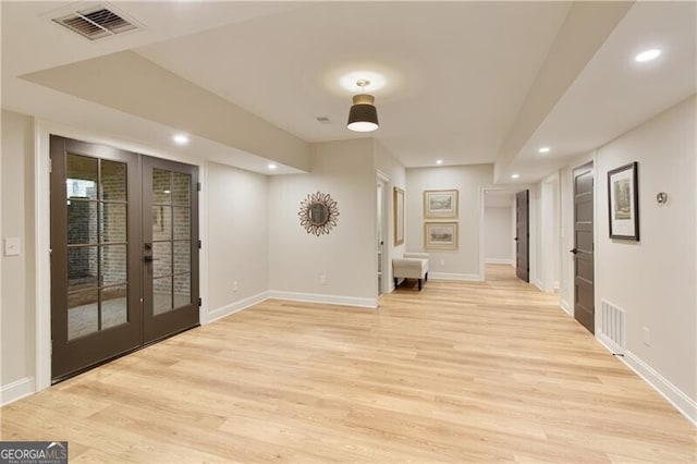 unfurnished room featuring french doors, light wood finished floors, baseboards, and recessed lighting