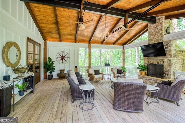 sunroom with wood ceiling, beam ceiling, a wooden deck, hardwood / wood-style flooring, and high vaulted ceiling