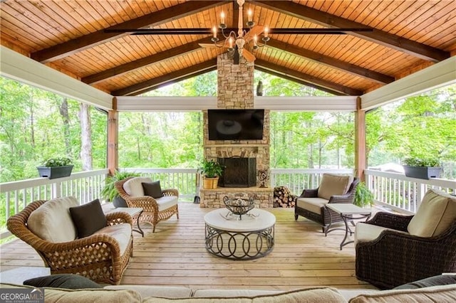 sunroom with an outdoor living space with a fireplace, ceiling fan, and healthy amount of natural light