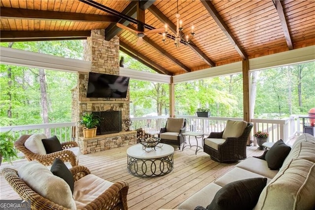 sunroom featuring an outdoor living space with a fireplace, a chandelier, and ceiling fan