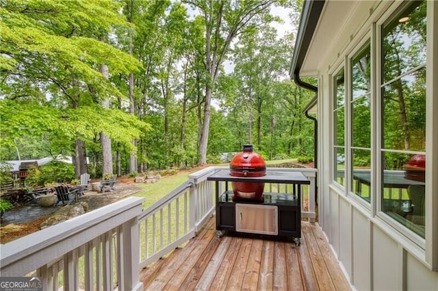 wooden terrace with view of scattered trees and a water view