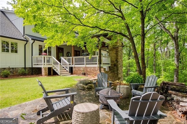 view of patio with an outdoor fire pit and stairway