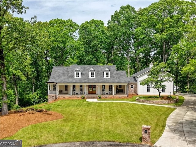 cape cod home featuring a porch, crawl space, a front yard, and view of scattered trees