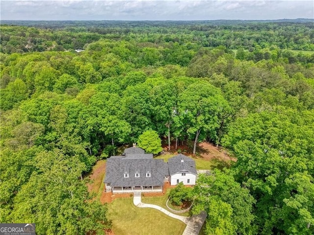 view of subject property with a heavily wooded area