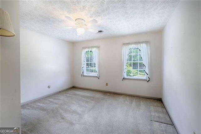 3625 Stonehenge Way NE, Marietta, GA 30066 - carpeted spare room featuring ceiling fan, a textured ceiling, and baseboards