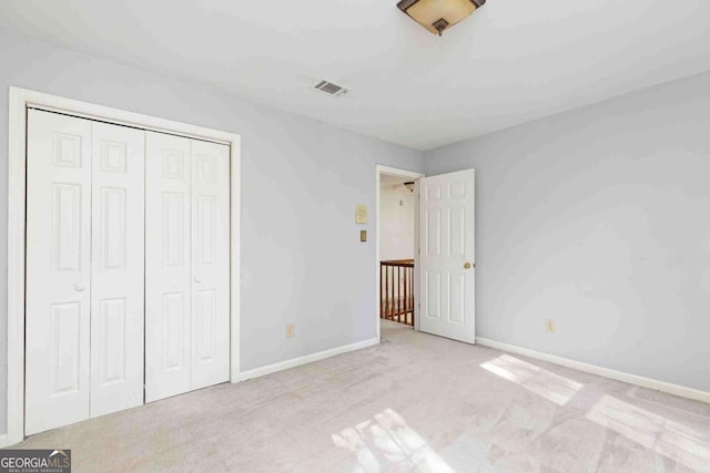 386 Collegiate Dr, Powder Springs, GA 30127 - unfurnished bedroom featuring carpet, a closet, and baseboards