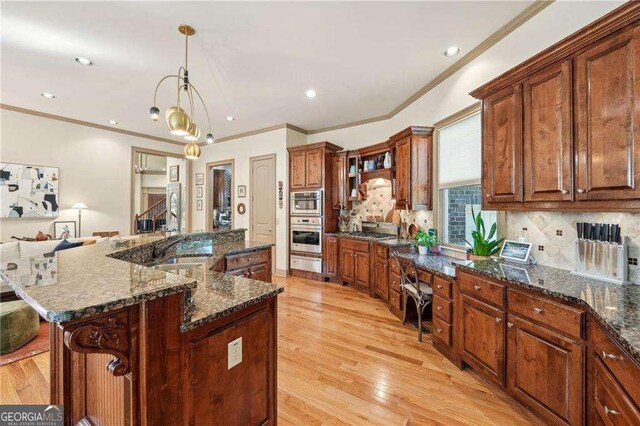 4162 Cumberland Point Dr, Gainesville, GA 30504 - kitchen with backsplash, light wood-style flooring, a warming drawer, crown molding, and dark stone countertops