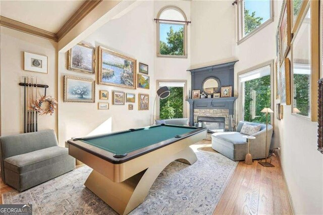 4162 Cumberland Point Dr, Gainesville, GA 30504 - recreation room featuring pool table, wood finished floors, plenty of natural light, a stone fireplace, and ornamental molding