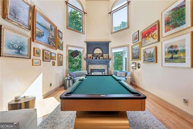 4162 Cumberland Point Dr, Gainesville, GA 30504 - recreation room with wood finished floors, a high ceiling, a stone fireplace, pool table, and baseboards