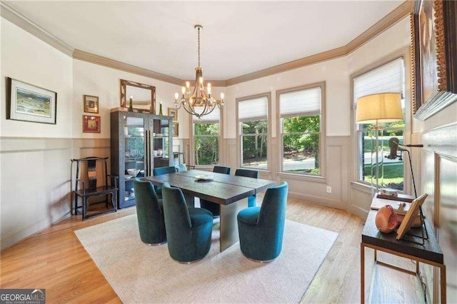 4162 Cumberland Point Dr, Gainesville, GA 30504 - dining space featuring a chandelier, a decorative wall, wainscoting, ornamental molding, and light wood-style flooring