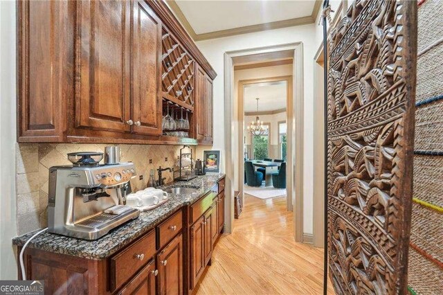 4162 Cumberland Point Dr, Gainesville, GA 30504 - bar with ornamental molding, a sink, decorative backsplash, light wood-style floors, and a chandelier