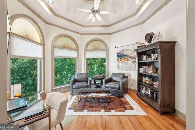 4162 Cumberland Point Dr, Gainesville, GA 30504 - sitting room featuring crown molding, wood finished floors, ceiling fan, and a tray ceiling