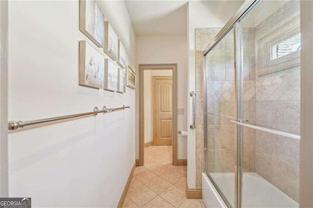 4162 Cumberland Point Dr, Gainesville, GA 30504 - full bath featuring tile patterned flooring, bath / shower combo with glass door, and baseboards