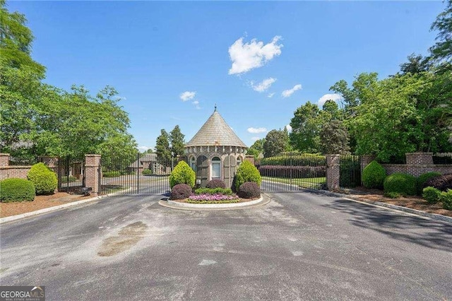 4162 Cumberland Point Dr, Gainesville, GA 30504 - view of asphalt road featuring a gate, curbs, and a gated entry