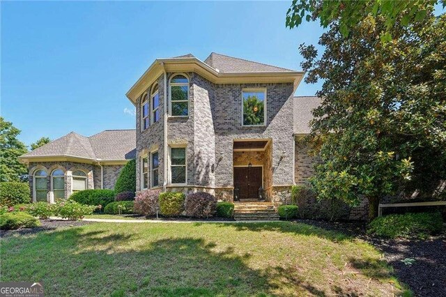 4162 Cumberland Point Dr, Gainesville, GA 30504 - view of front facade with a front lawn, stone siding, and brick siding