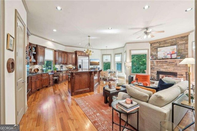 4162 Cumberland Point Dr, Gainesville, GA 30504 - living room featuring ornamental molding, ceiling fan, light wood-style floors, recessed lighting, and a fireplace
