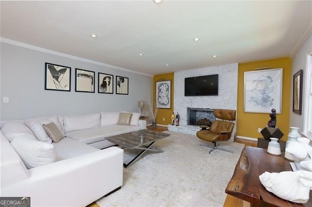 living area featuring wood finished floors, a fireplace, ornamental molding, baseboards, and recessed lighting