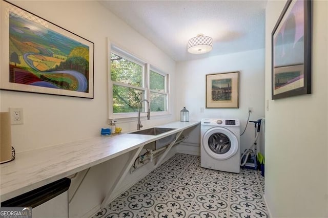 clothes washing area featuring washer / dryer, baseboards, and an office area