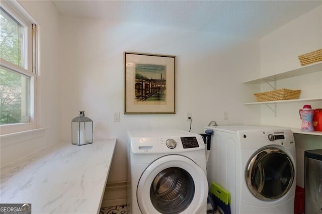laundry room featuring independent washer and dryer and healthy amount of natural light