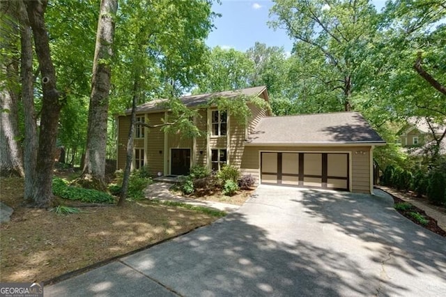 colonial inspired home featuring driveway and a garage