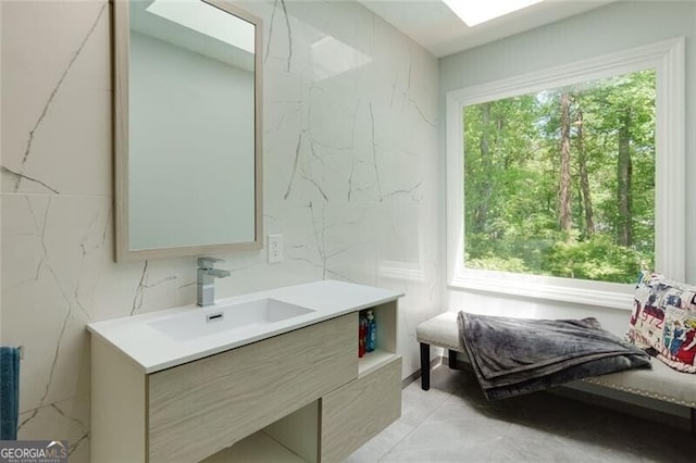 bathroom featuring vanity and a skylight