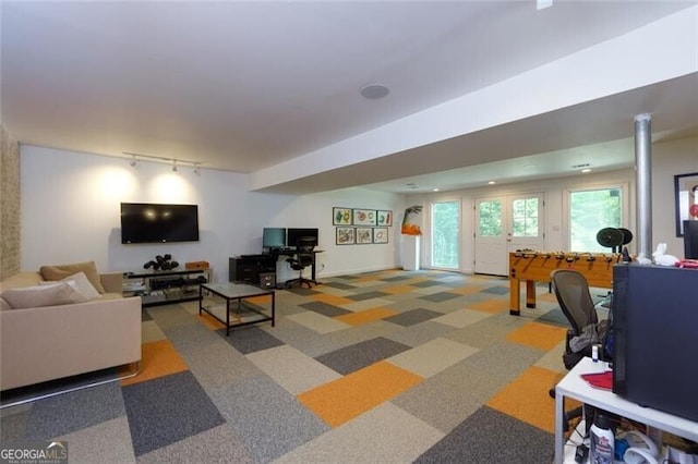 carpeted living area with track lighting