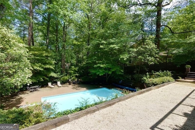 outdoor pool with a patio area