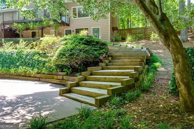 view of yard featuring stairs, fence, and a patio