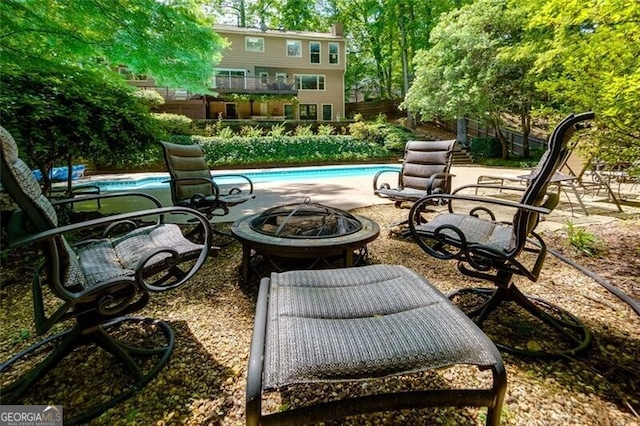 view of patio / terrace featuring an outdoor fire pit and fence