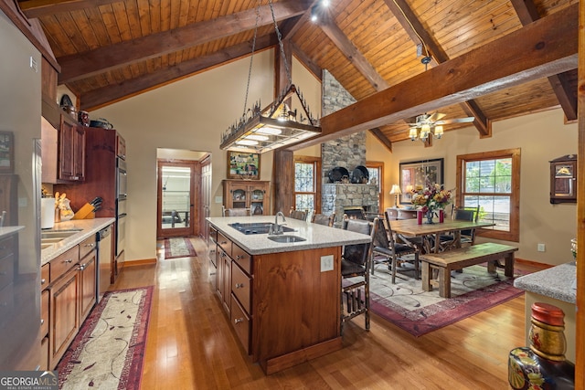 259 Eagle Chase Cir, Dillard, GA 30537 - kitchen featuring wood ceiling, a stone fireplace, baseboards, ceiling fan, and light wood-type flooring