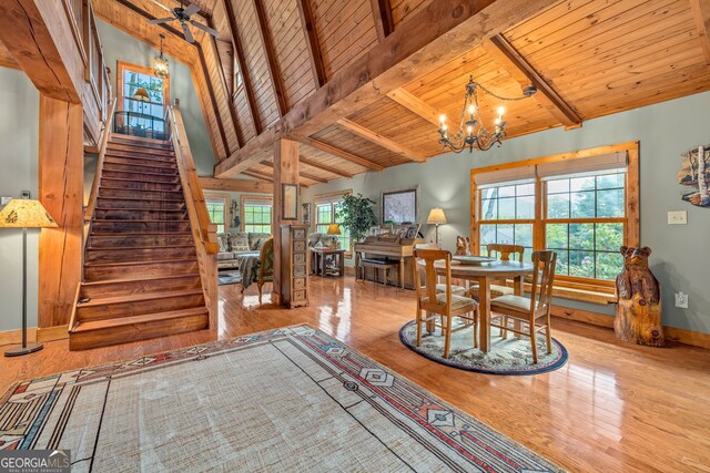 259 Eagle Chase Cir, Dillard, GA 30537 - dining room featuring wood finished floors, a chandelier, stairway, beam ceiling, and wooden ceiling