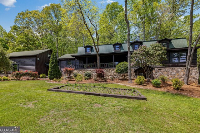 259 Eagle Chase Cir, Dillard, GA 30537 - back of house featuring a lawn, stone siding, and metal roof